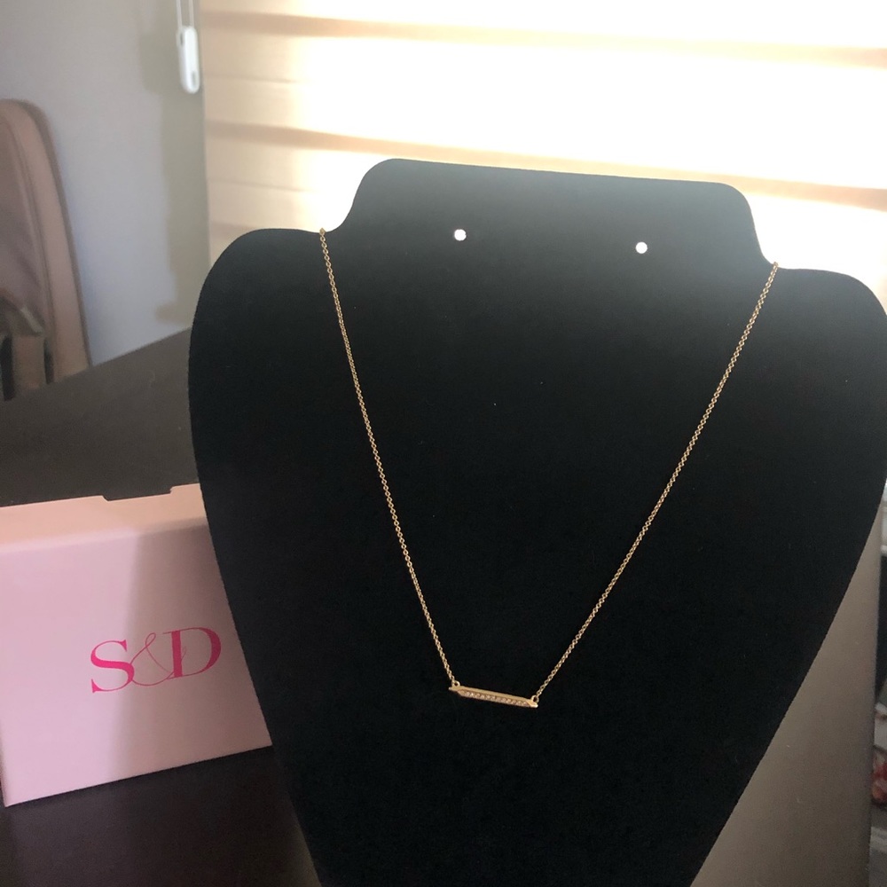Gold bar necklace.